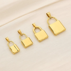 Polished gold stainless steel lock pendants in four sizes displayed on silk background