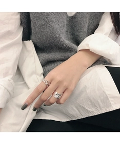 Detail showing irregular texture and retro finish of S925 silver rings on model hand