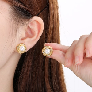 Textured gold stainless steel stud earrings featuring white pearls in a vintage style