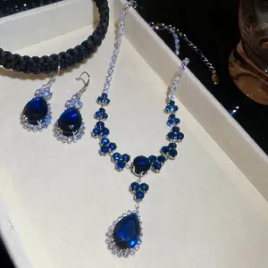 Elegant silver necklace and earrings set with pear-cut blue zircon stones