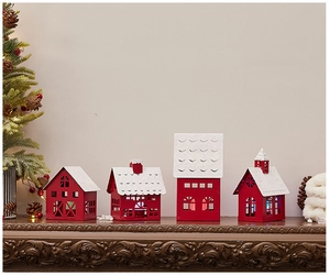 Detail of red and white metal Christmas house candle holders on a festive mantelpiece