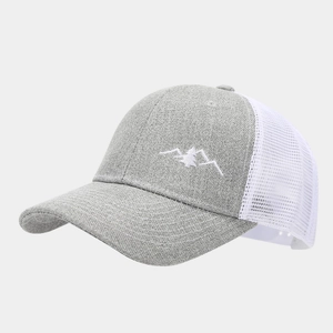 Detail of grey fabric front and white breathable mesh back with mountain embroidery