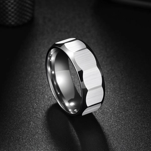 Macro view of men's stainless steel ring with faceted matte finish and polished edges