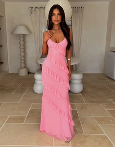 Detailed view of pink backless maxi dress featuring diagonal ruffles and side slit design