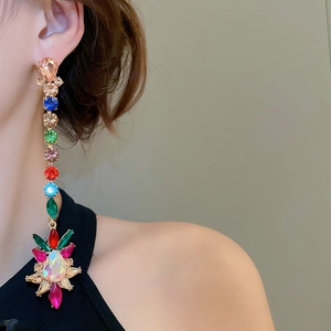 Detail view of multicolored crystal drop earrings with sparkling multi-tone gemstones
