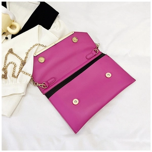 Detailed interior of rose red chain envelope bag with black lining and magnetic gold clasps