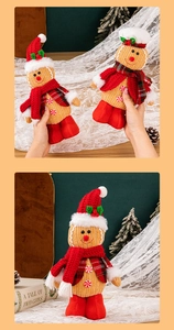Close-up of knitted gingerbread man plush toys with red scarves and festive decorations