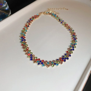 Dettaglio di un girocollo con strass colorati con base dorata e catena regolabile