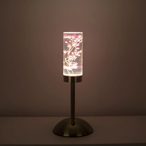 Detailed view of pink preserved flowers inside a cylindrical acrylic LED bedside lamp