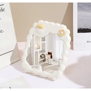 Detail of white cloud-shaped desktop makeup mirror with cute cartoon sheep and flower decor