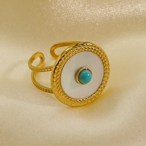 Macro shot of 14K gold-plated adjustable ring with turquoise stone and shell inlays
