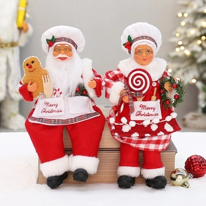 Standing Chef Santa and Mrs. Claus Christmas figurines with striped hats and gingerbread props