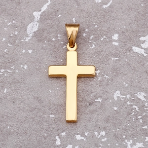 Minimalist gold cross pendant made of stainless steel displayed on a stone surface
