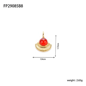 Detailed fan-shaped gold pendant with red cabochon stone and radial texture detail