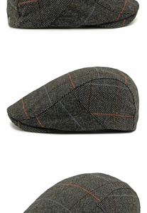 Detailed view of grey herringbone wool flat cap with orange and blue windowpane check