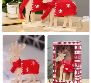 Close-up of wooden reindeer with red felt shawl and matching Christmas gift box packaging