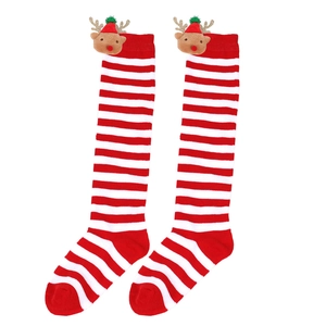 Detail of red and white striped Christmas stockings with plush reindeer doll decorations