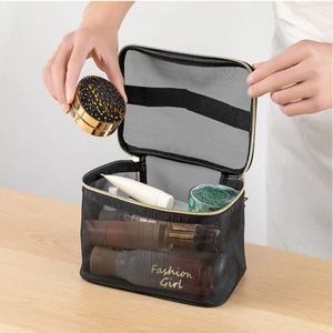 Detail view of double-layer mesh toiletry bag with golden zipper and inner brush holders