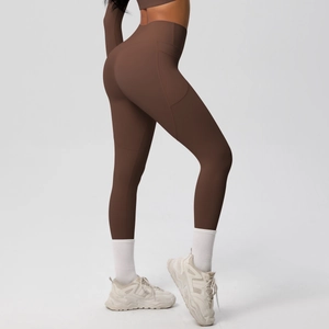 Detail of high waisted brown yoga leggings with side pockets and bum lifting seams