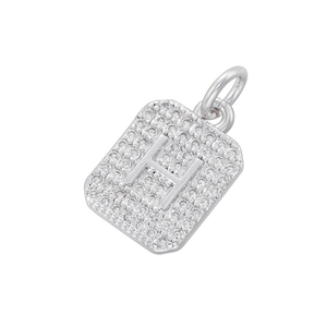 Macro shot of silver square letter H pendant with pavé set zircon stones