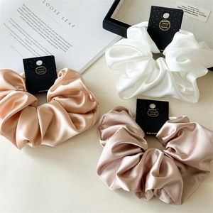 Three oversized 18cm satin scrunchies in champagne, white and rose gold silk fabric