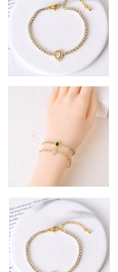 Close-up of gold titanium steel bracelets with pear and oval-cut cubic zirconia stones