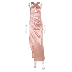 Detail of pink satin halter neck dress featuring cross-strap design and high side slit