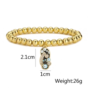Detailed close-up of 18K gold-plated beaded bracelet with Evil Eye slipper charm