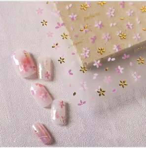 Detail of pink and gold Sakura cherry blossom embossed 3D nail art stickers and petals