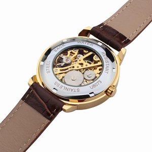 Macro shot of transparent stainless steel case back revealing mechanical watch movement