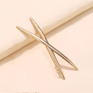 Close-up of minimalist golden alloy hair pin set with a geometric X-shaped design