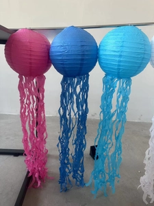 Detail of jellyfish paper lanterns with long streamers for mermaid ocean party decor