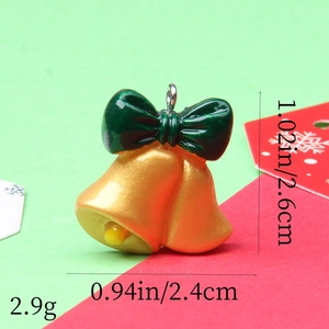 Detailed view of Christmas resin bells pendant with size labels 2.6cm by 2.4cm