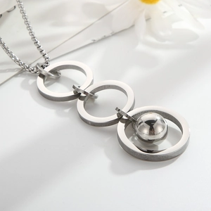 Detail of three-tier linked rings necklace with a movable steel bead and silver finish