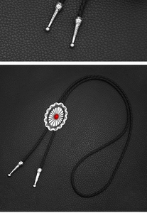 Detailed close-up of a silver Celtic Bolo Tie with red gemstone inlay and braided leather cord