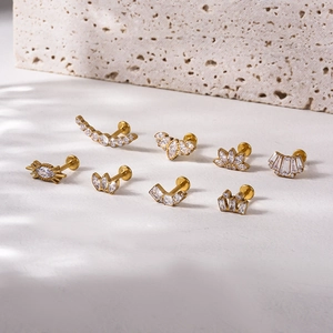 Golden F136 titanium piercing studs with marquise zircon stones and crown designs