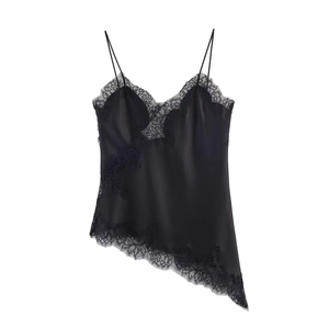 Detail of black silk camisole top with lace trim and asymmetrical hem on white background