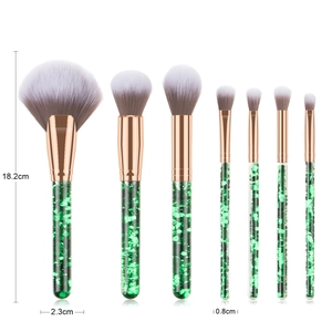 Detailed view of 7pcs makeup brush set with green glitter handles and rose gold ferrules