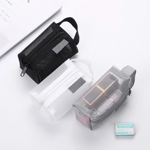 Three mesh organizer bags in black, white, and gray with zippers and side handles