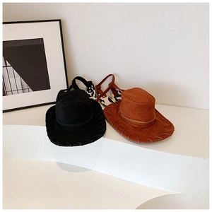 Detail of western cowboy hats with hand-stitched brim and cow print sandals