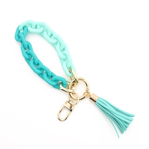 Detail of gradient green acrylic link keychain with a matching mint tassel and gold ring