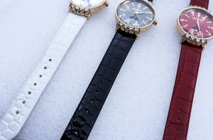Detailed display of ladies' watches in white, black, and red with crocodile leather straps