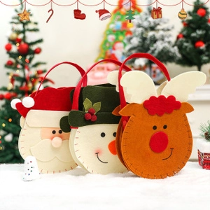 Three felt Christmas gift bags featuring Santa, snowman, and reindeer designs with handles