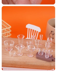 Detailed shot of miniature clear resin wine and champagne glasses for dollhouse decor