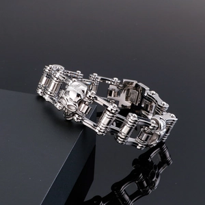 Close-up of polished stainless steel men's biker bracelet with skull details