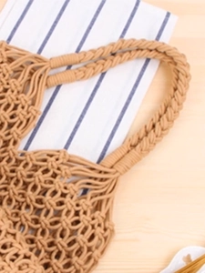 Handcrafted khaki woven mesh tote bag with reinforced handles for summer beach vacation