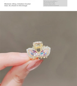 Close-up of golden butterfly hair claw clip with colorful marquise crystals and rhinestones