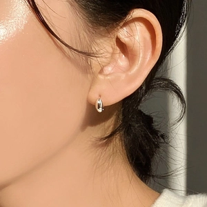 Minimalist 925 sterling silver oval hoop earrings shown on model for a sleek daily look