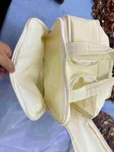 Detail view of large travel toiletry bag with wide opening and double zipper compartments