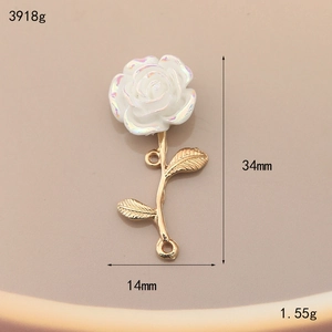 Macro detail of a 34mm white resin rose charm with golden alloy stem for DIY jewelry